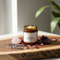 Organic body butter in amber glass jar on wood surface with dried lavender, rose petals and amethyst